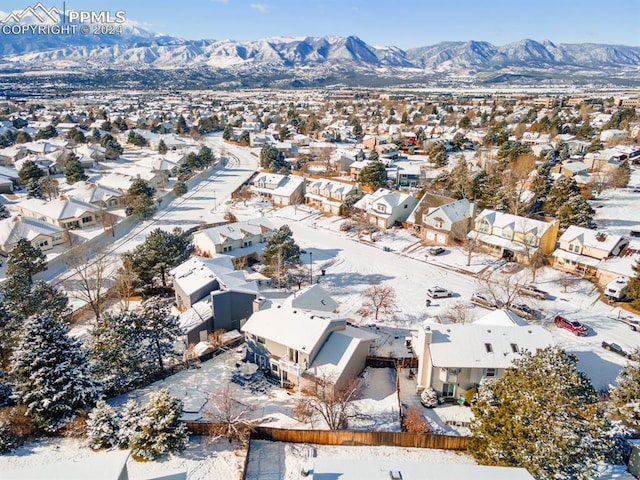 snowy aerial view with a mountain view