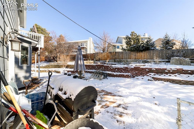 snowy yard with a balcony