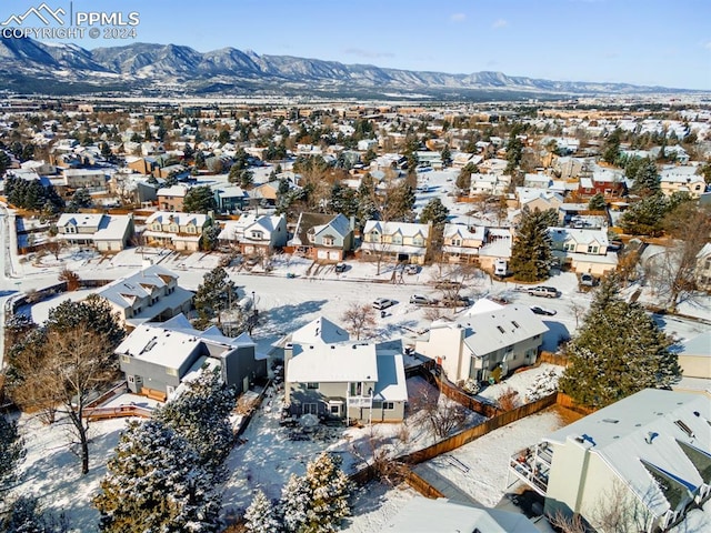 snowy aerial view featuring a mountain view