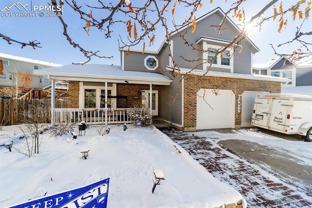 view of front of house featuring covered porch and a garage