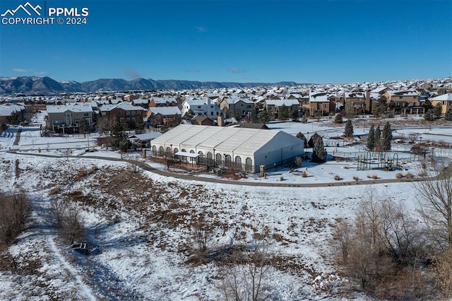 snowy aerial view featuring a mountain view