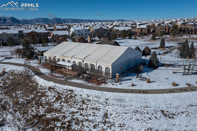 snowy aerial view with a mountain view