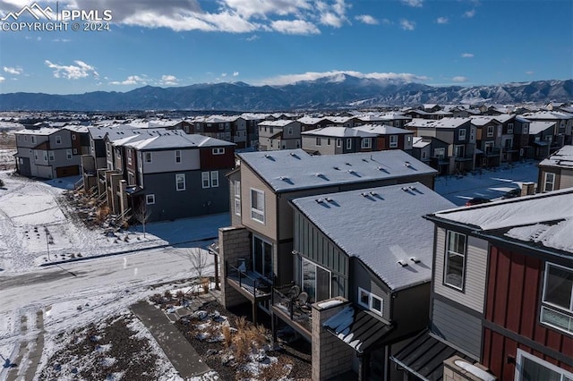 snowy aerial view with a mountain view