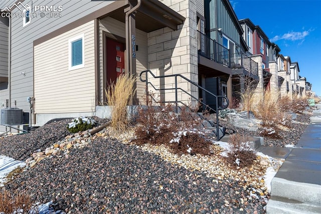 view of snowy exterior with central AC