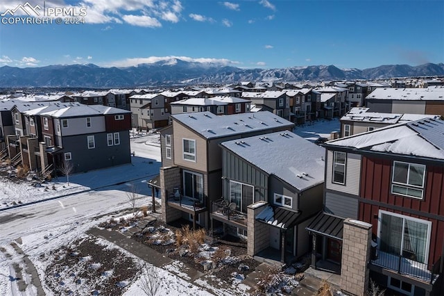 snowy aerial view with a mountain view