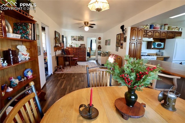 dining room with dark hardwood / wood-style floors and ceiling fan