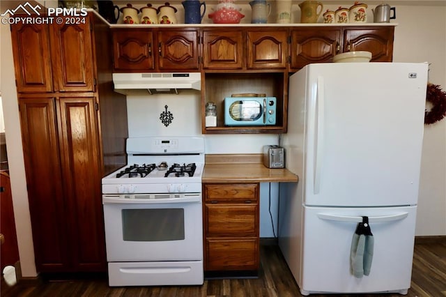 kitchen featuring dark hardwood / wood-style flooring and white appliances