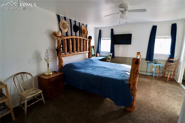 carpeted bedroom with baseboard heating, multiple windows, and ceiling fan