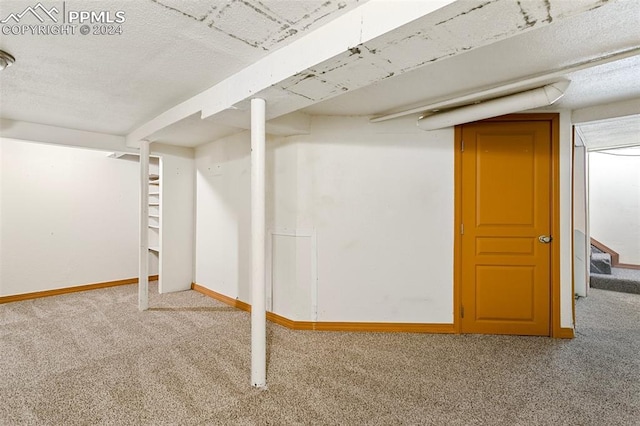 928 Alexander Rd, Colorado Springs, CO 80909 - basement with a textured ceiling and carpet floors