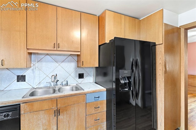 928 Alexander Rd, Colorado Springs, CO 80909 - kitchen featuring decorative backsplash, light wood-type flooring, black appliances, and sink