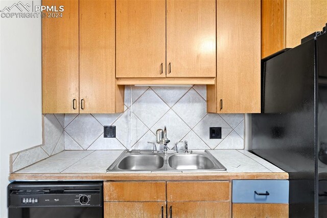 928 Alexander Rd, Colorado Springs, CO 80909 - kitchen with tasteful backsplash, sink, and black appliances