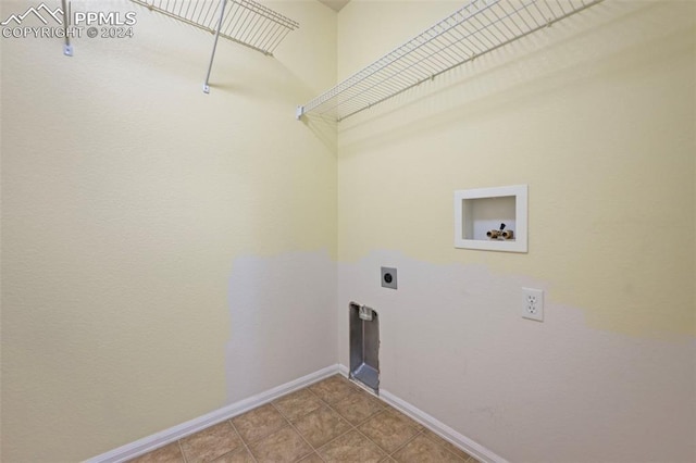 washroom featuring hookup for a washing machine, electric dryer hookup, and light tile patterned flooring