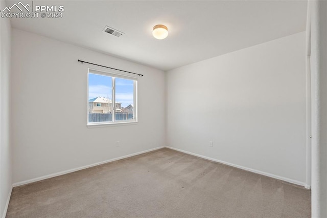 empty room featuring light carpet