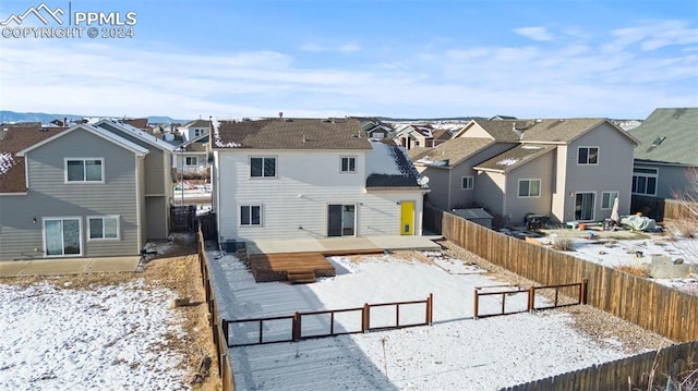 snow covered property featuring a deck