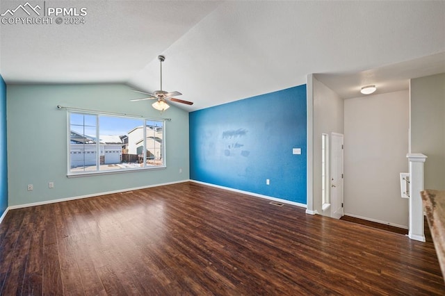 unfurnished living room featuring vaulted ceiling, ceiling fan, and dark wood-type flooring