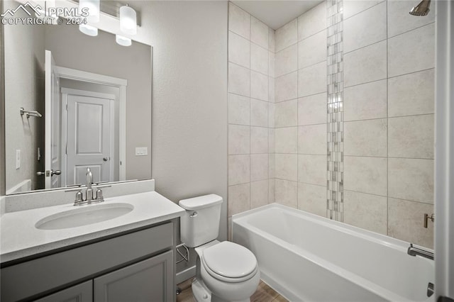 full bathroom with vanity, toilet, and tiled shower / bath