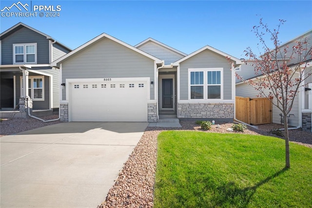 view of front of property with a front lawn and a garage