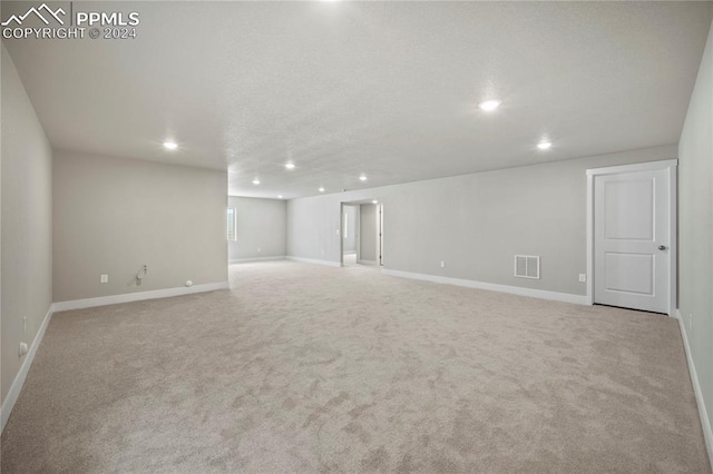 unfurnished room featuring light colored carpet