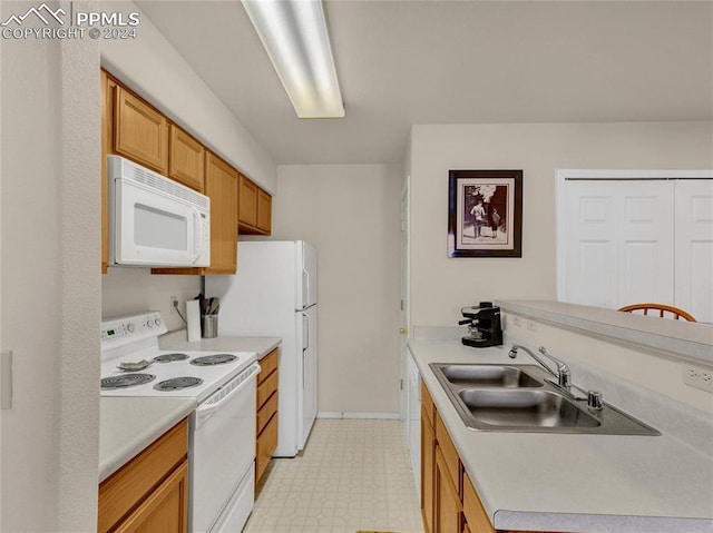 kitchen featuring white appliances and sink