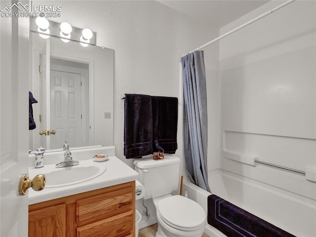 full bathroom featuring vanity, shower / bath combination with curtain, and toilet