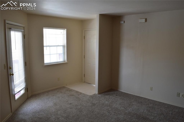 carpeted spare room with a healthy amount of sunlight