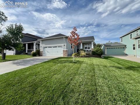 ranch-style house with a front yard and a garage