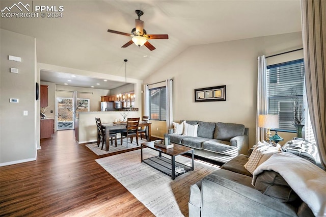 living room featuring ceiling fan with notable chandelier, lofted ceiling, and dark wood-type flooring