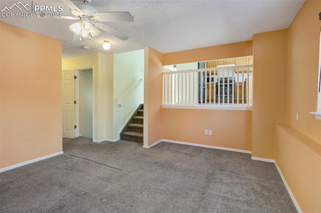 spare room featuring carpet flooring, ceiling fan, and a textured ceiling