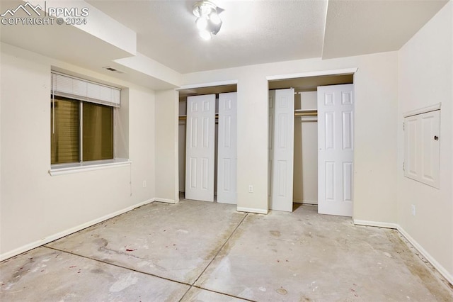 unfurnished bedroom with two closets