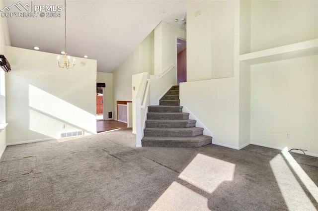 stairs featuring carpet flooring, high vaulted ceiling, and an inviting chandelier