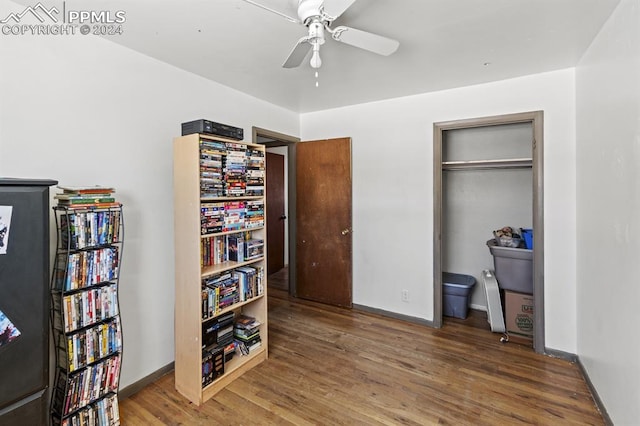 bedroom with hardwood / wood-style floors, a closet, and ceiling fan