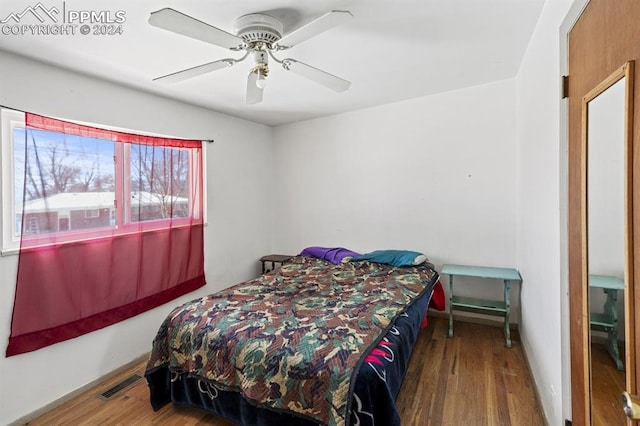 bedroom featuring hardwood / wood-style flooring and ceiling fan