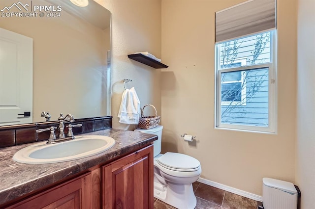 bathroom with tile patterned floors, toilet, and vanity