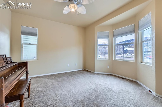 unfurnished room with ceiling fan and carpet floors