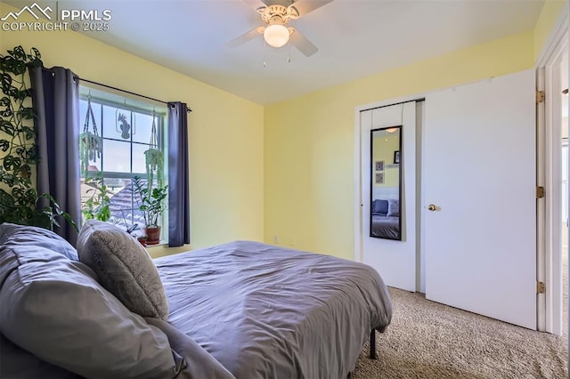 carpeted bedroom with ceiling fan and a closet