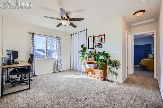 carpeted office space featuring ceiling fan