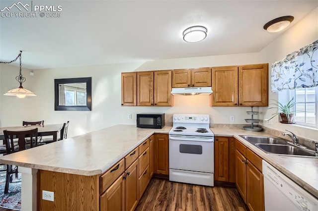 kitchen featuring sink, dark hardwood / wood-style flooring, hanging light fixtures, kitchen peninsula, and white appliances