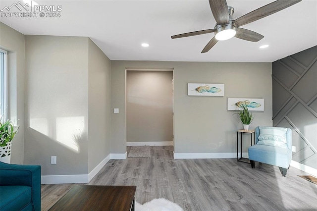 unfurnished room with ceiling fan and light wood-type flooring