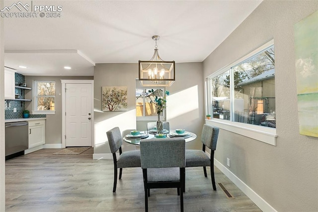 dining room featuring a notable chandelier and light hardwood / wood-style flooring