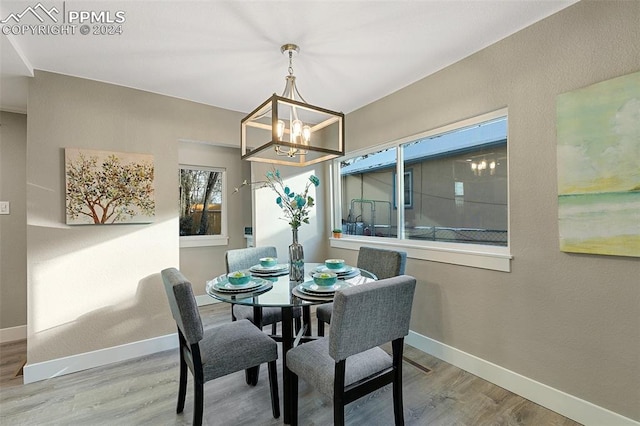 dining area with a chandelier and hardwood / wood-style flooring