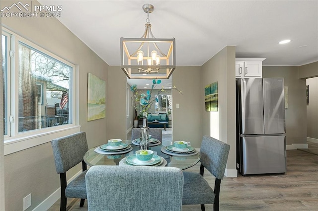 dining room featuring a notable chandelier and hardwood / wood-style flooring