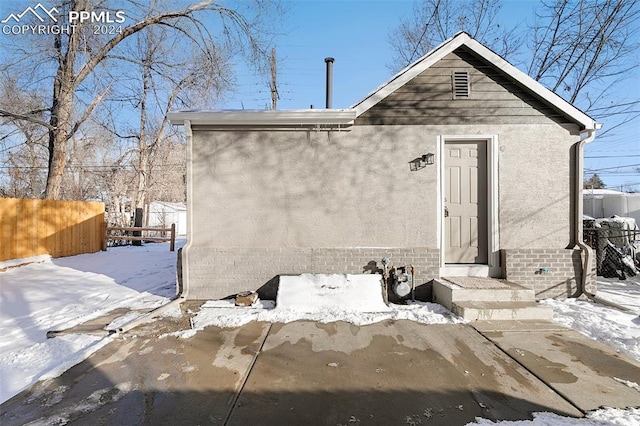 view of snow covered rear of property