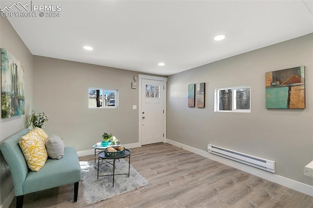 interior space featuring a baseboard radiator and light hardwood / wood-style floors