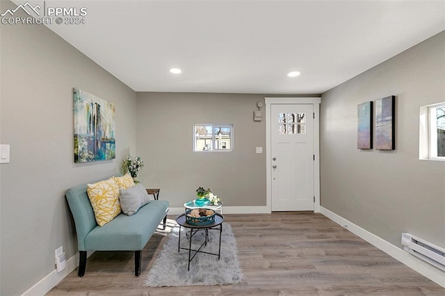 entrance foyer featuring a baseboard radiator and light hardwood / wood-style flooring