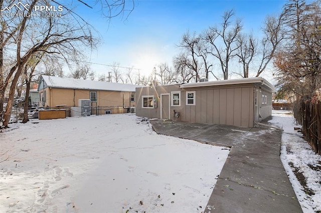 view of snow covered back of property