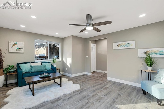 living room featuring ceiling fan and light wood-type flooring