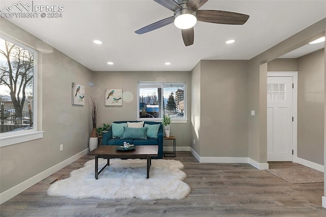 sitting room with hardwood / wood-style floors, a wealth of natural light, and ceiling fan