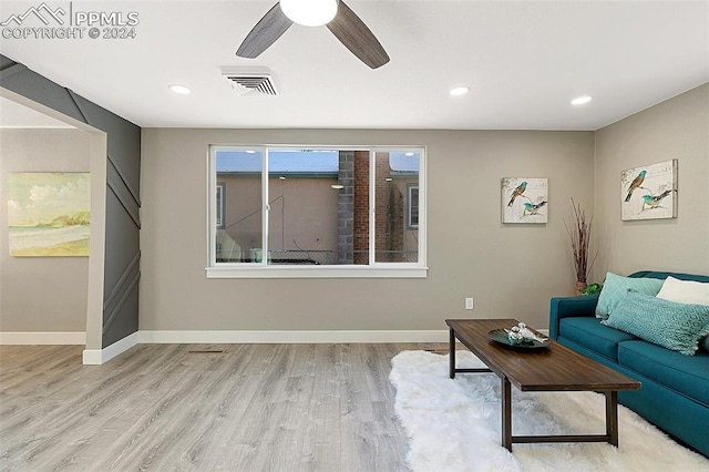 living room with ceiling fan and light hardwood / wood-style flooring