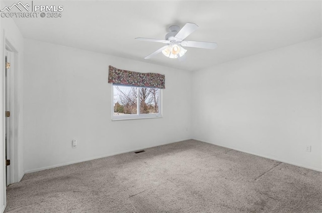 empty room with ceiling fan and carpet floors