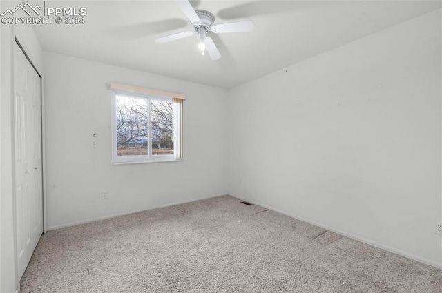 spare room with carpet flooring and ceiling fan